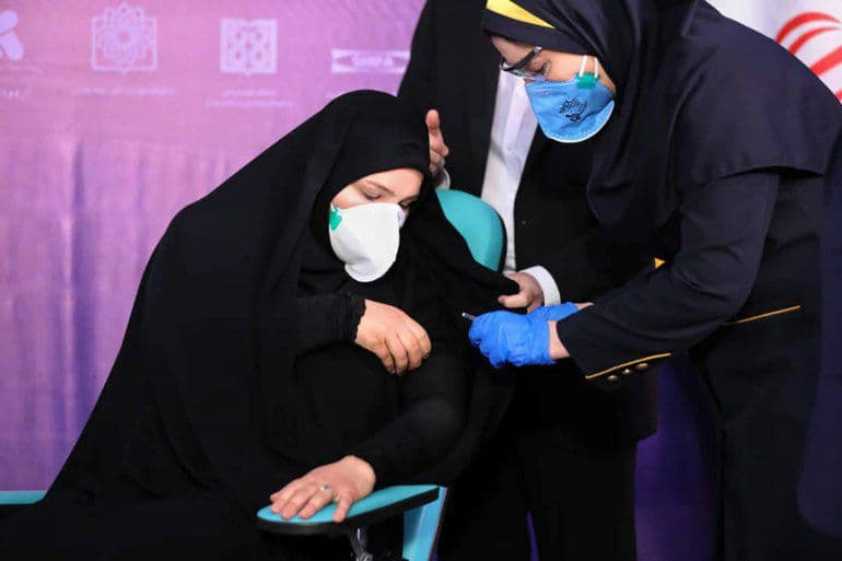 A nurse prepares to inject a volunteer taking part in an Iranian Covid vaccine trial in Tehran, Iran