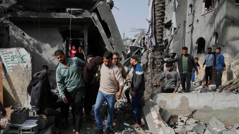 Palestinians retrieve a body from the rubble of a building destroyed by an Israeli airstrike in Deir al-Balah, Gaza Strip, on Monday, April 7, 2025. (AP Photo/Abdel Kareem Hana)
