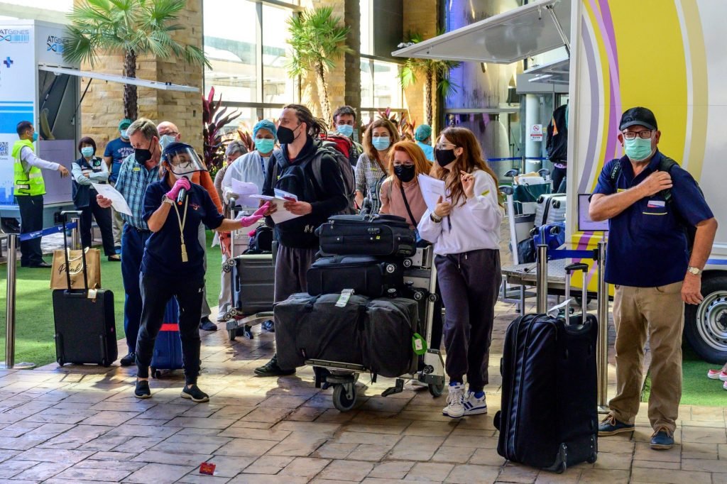 An airport employee assists passengers through the arrival area at Phuket International Airport. Photo: AFP