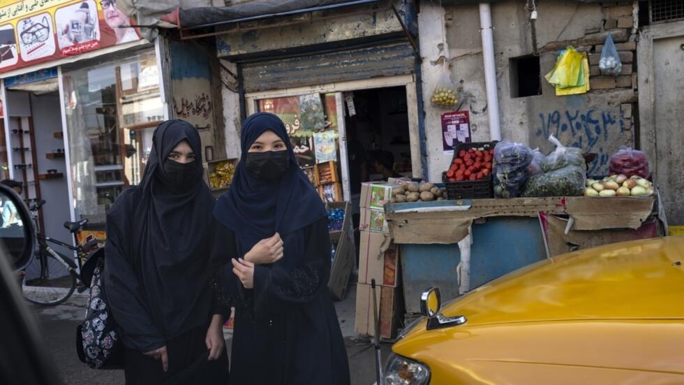 Women walk by a street market in Kabul, Afghanistan on Tuesday, June 6, 2023. Photo: Rodrigo Abd, AP