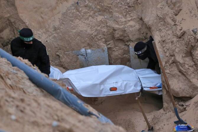Hamas militants carry a body retrieved from a tunnel in northern Khan Yunis, southern Gaza Strip, on October 28, 2025. (File/AFP)