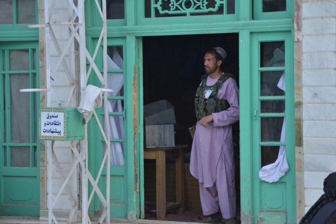 A Taliban fighter looks out from inside a Shiite mosque in Kandahar on October 15, 2021. (AFP)