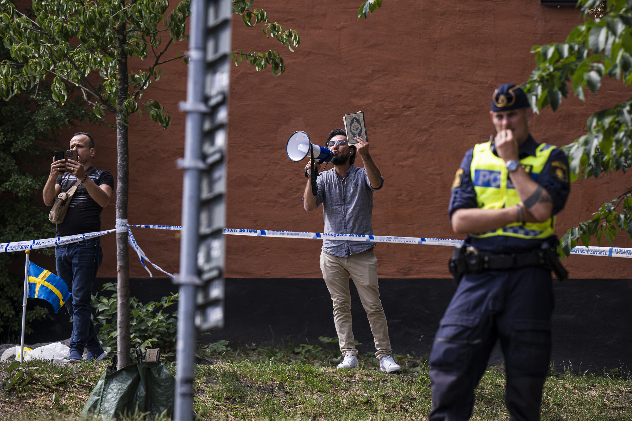 Salwan Momika holds a Quran as he protests outside a mosque in Stockholm on June 28, 2023, during the Eid al-Adha holiday. (Photo:AFP)
