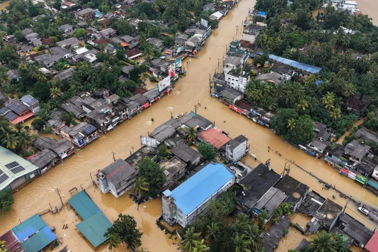 An aerial view shows houses partially submerged in floodwaters after heavy rainfall in Kaduwela on the outskirts of Colombo [AFP]