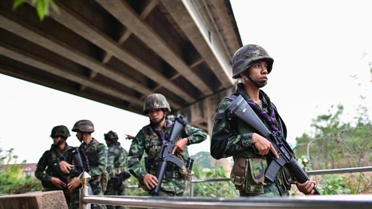 Thai military personnel stand guard overlooking the Moei river on the Thai side of the shared border with Myanmar. Photo: Manan Vatsyayana/AFP