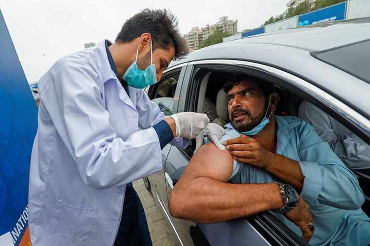 A resident receiving Covid-19 vaccine at a drive-through vaccination facility in Karachi, Pakistan.