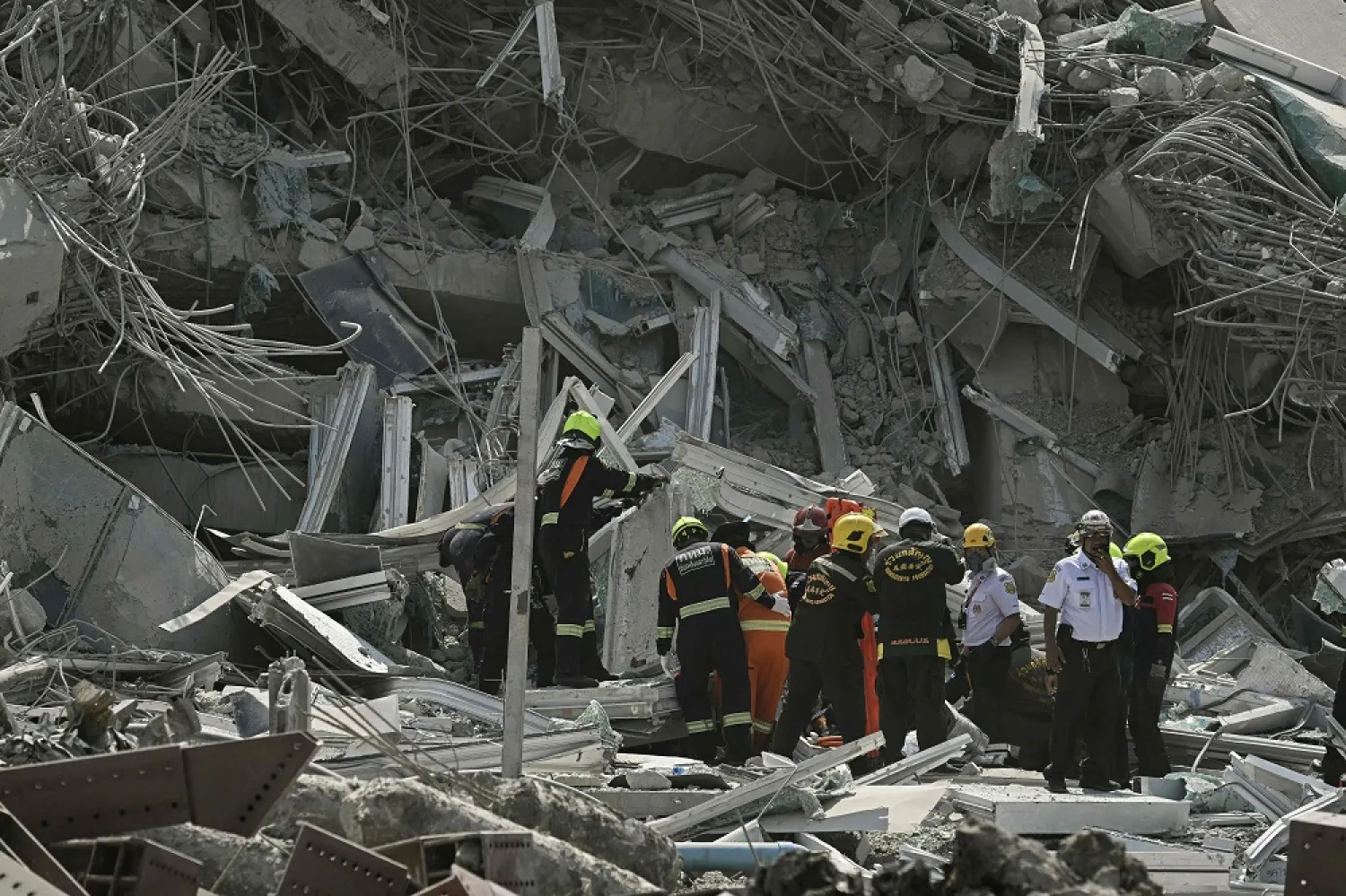 Rescue teams are seen at a construction site where a building collapsed in Bangkok on March 28, 2025, after an earthquake. (AFP)