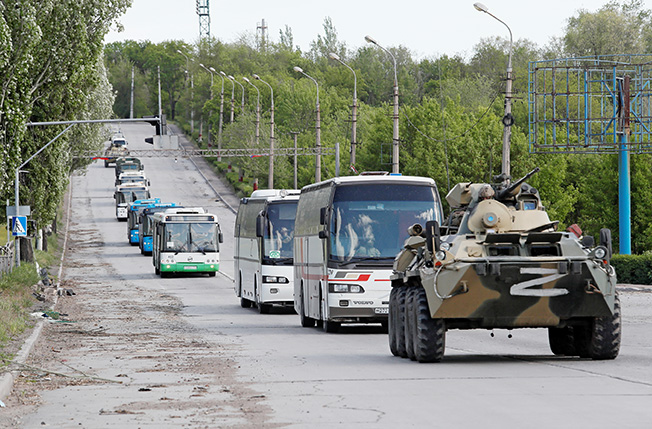 Buses carrying service members of Ukrainian forces who have surrendered after weeks holed up at Azovstal steel works leave Mariupol