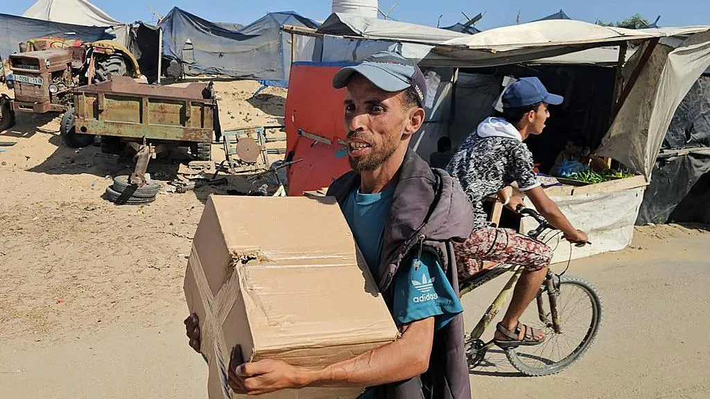 A Palestinian man was pictured with a GHF-branded food parcel in the southern city of Rafah on Tuesday