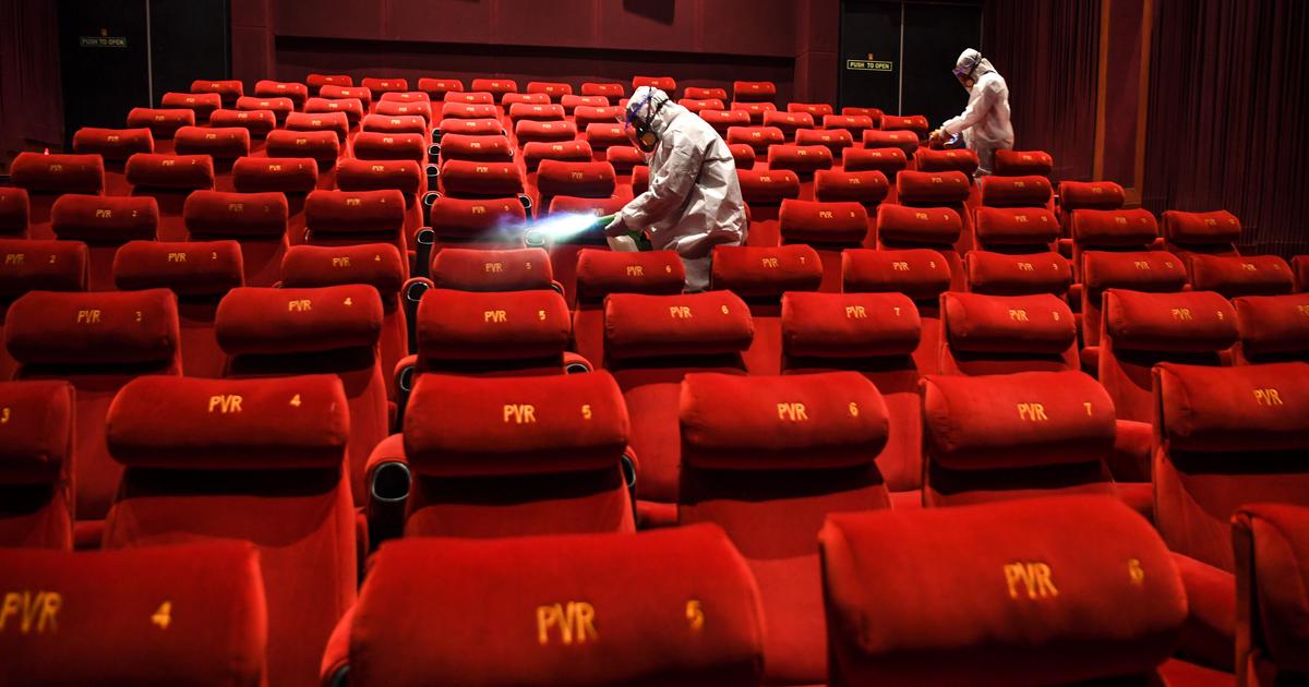 PVR Cinemas employees sanitizing a cinema hall