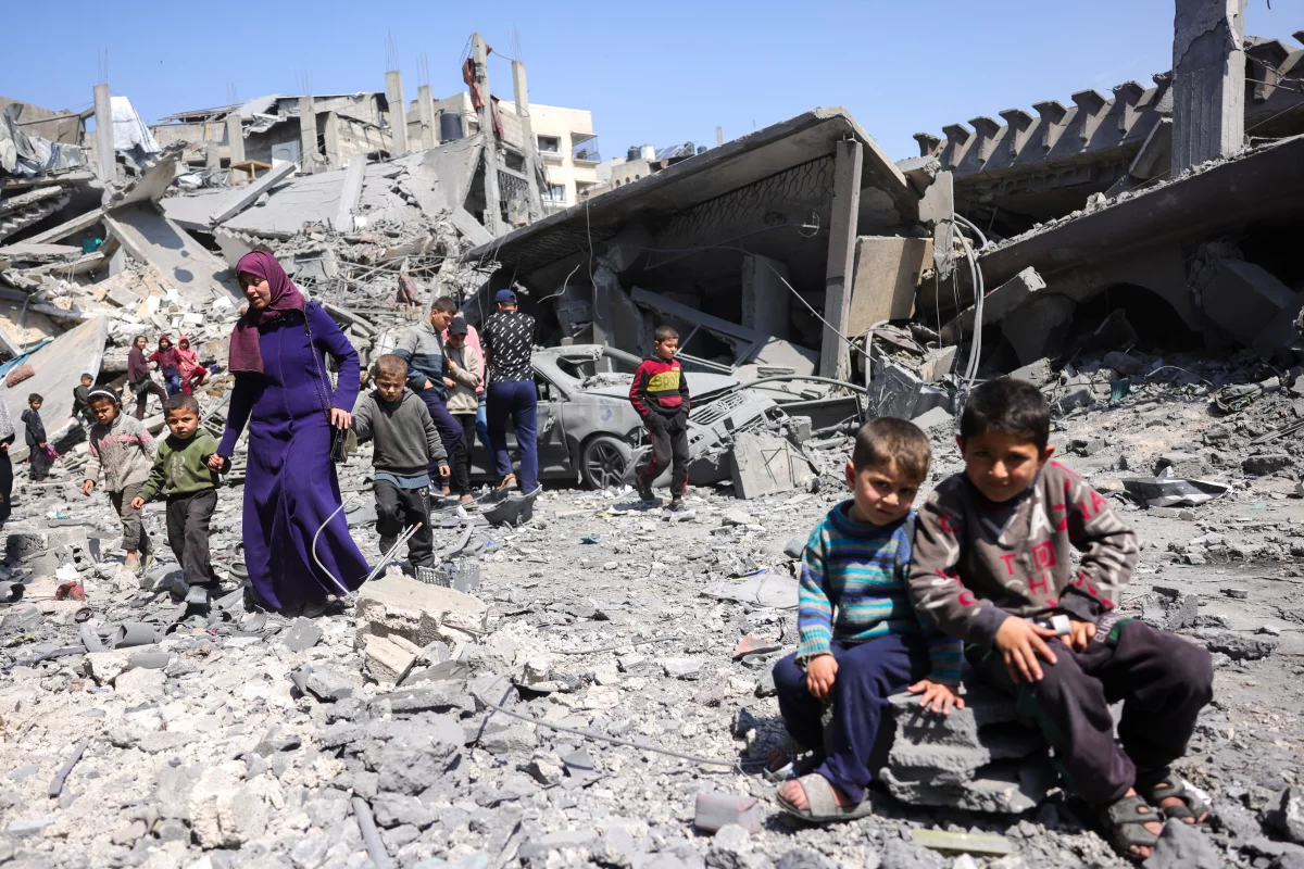 Children stand amid the rubble in Jabalia after an overnight Israeli strike, as Israel resumes operations in Gaza citing the need to rescue hostages. (Bashar Taleb / AFP via Getty Images)