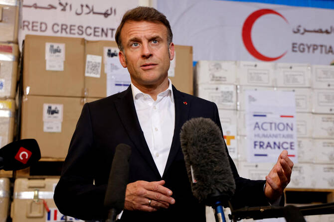 France’s President Emmanuel Macron speaking in front of humanitarian aid destined to Gaza, at the Egyptian Red Crescent warehouse in Arish, Egypt, April 8, 2025. (Reuters)