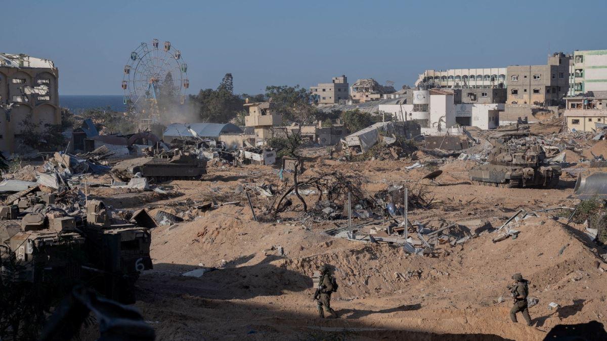 Israeli soldiers walk during an operation, amid the ongoing conflict between Israel and Hamas, as they continue their ground offensive in Gaza on November 7, 2023