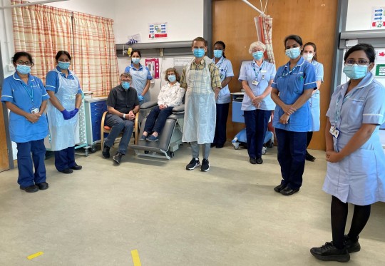 Andrew and Helen Clarke with the clinical team in Manchester after getting their trial vaccines.