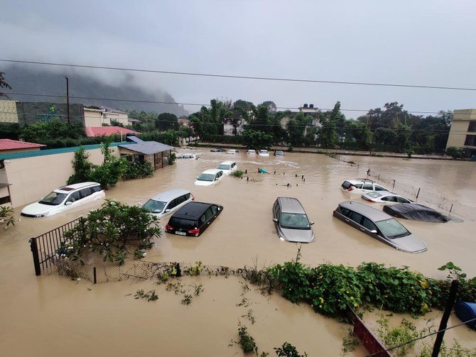 Submerged cars are seen at a flooded hotel resort as extreme rainfall caused the Kosi River to overflow at the Jim Corbett National Park in Uttarakhand, India