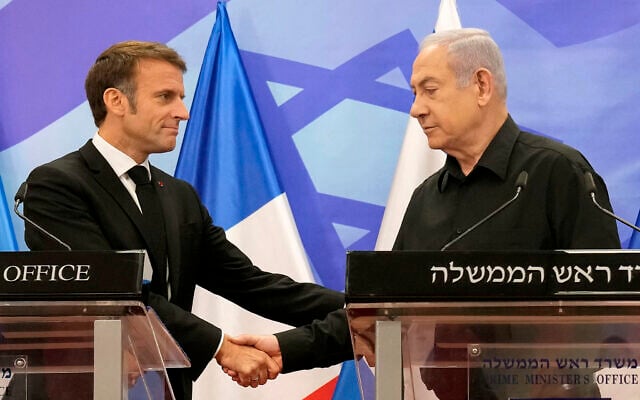 Prime Minister Benjamin Netanyahu (R) shakes hands with French President Emmanuel Macron (L), as they hold a joint press conference in Jerusalem on October 24, 2023. (Christophe Ena/Pool/AFP)