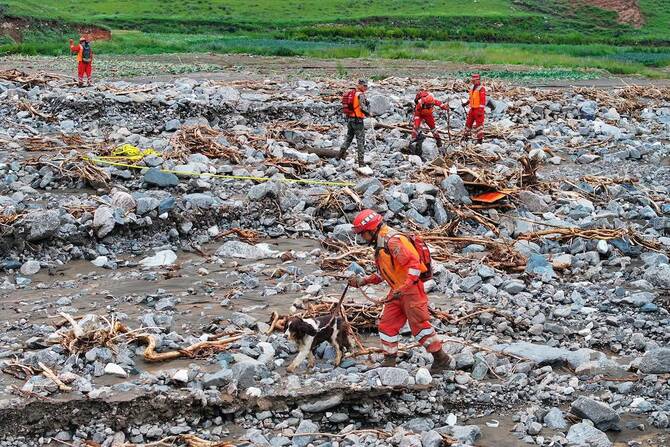 rescue workers search for victims a day after a flash flood in Yuzhong county. (AFP)